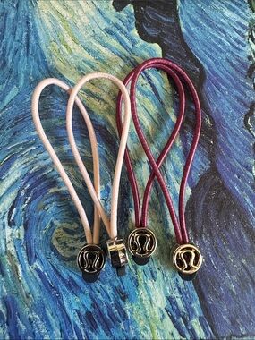 lululemon athletica cream and Burgundy Hair Ties or zipper pull Set